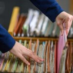 Employment records being retrieved from a file drawer