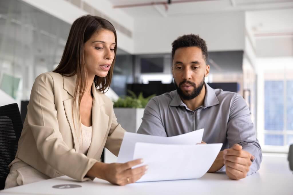 Manager and employee reviewing accommodation paperwork together