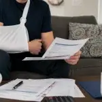 Injured California worker reviewing workers' compensation benefit paperwork