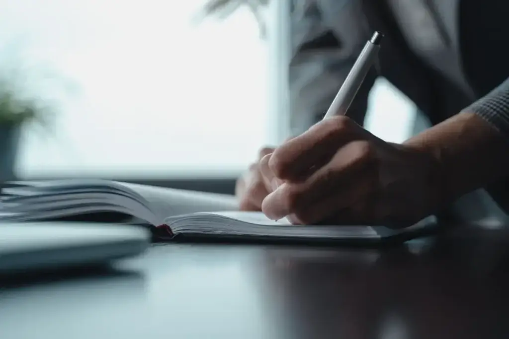 Employee writing down a timeline of events to support a retaliation lawsuit settlement claim