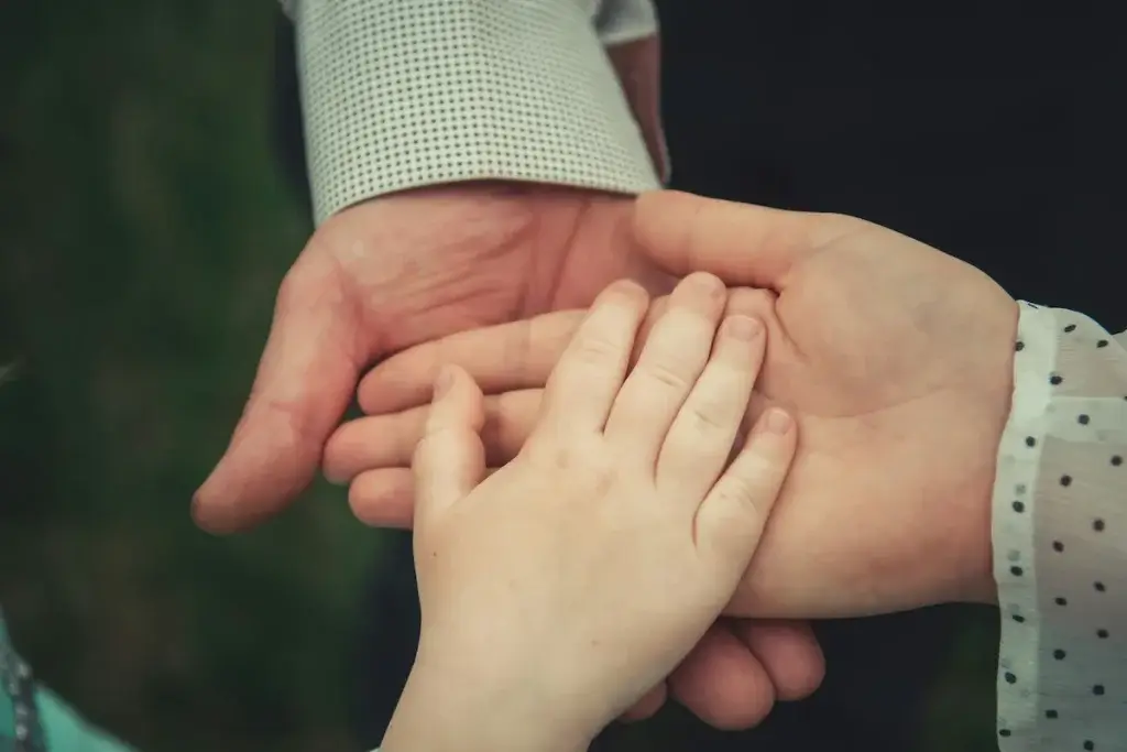 Three generations of family members holding hands, representing who can file a wrongful death claim in California.