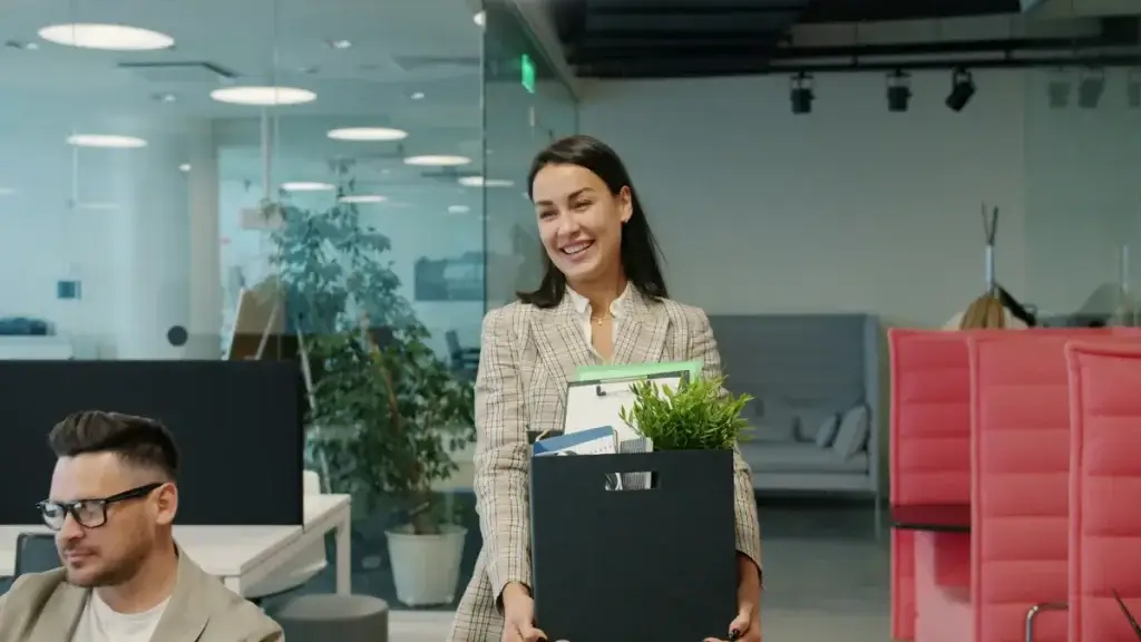 Employee packing personal items into a box after losing a job in California.