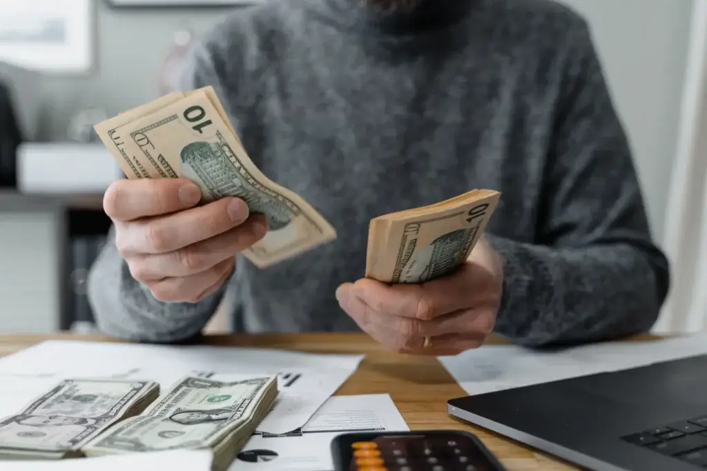 Worker counting cash pay under the minimum wage in California 2027