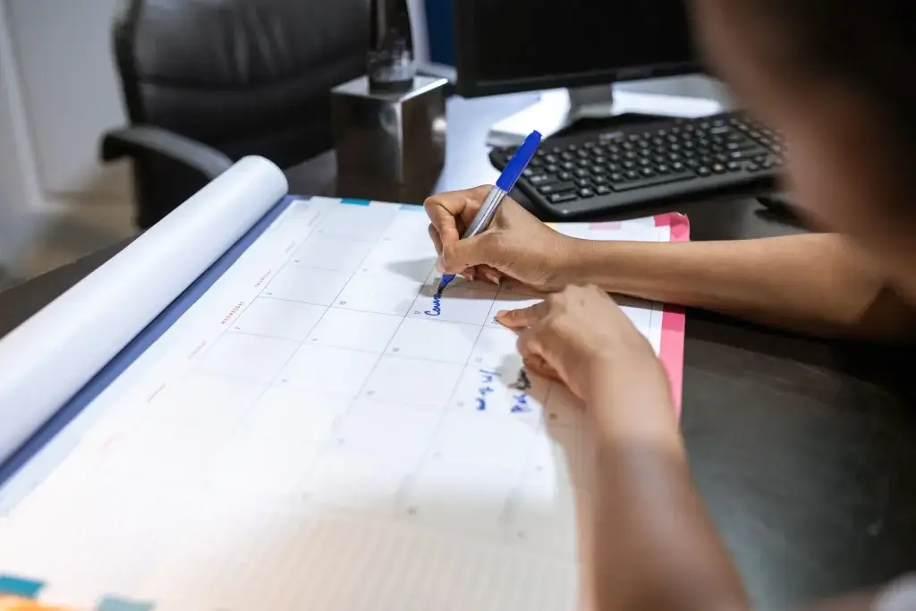 Parent marking bonding leave dates on a calendar